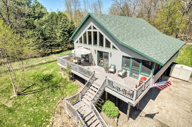 1351 Lone Pine Ln, Garfield Twp, WI 54001 - back of house featuring a deck, a shingled roof, a storage unit, and an outdoor structure