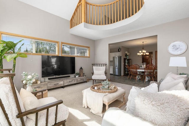 681 4th St NE, Little Falls, MN 56345 - living room featuring a chandelier, a high ceiling, and carpet floors