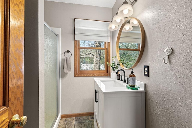 681 4th St NE, Little Falls, MN 56345 - bathroom with a stall shower, vanity, and baseboards
