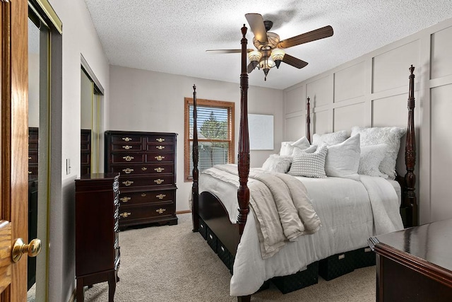 681 4th St NE, Little Falls, MN 56345 - bedroom featuring light carpet, a textured ceiling, ceiling fan, a closet, and a decorative wall