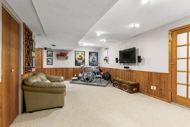 681 4th St NE, Little Falls, MN 56345 - carpeted living room featuring a wainscoted wall, wood walls, and a textured ceiling