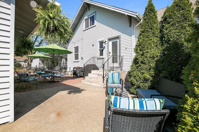 681 4th St NE, Little Falls, MN 56345 - back of property featuring a patio area and outdoor dining area