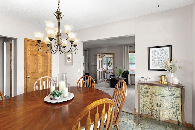 681 4th St NE, Little Falls, MN 56345 - dining area featuring a chandelier, light stone finish floors, baseboards, and a textured ceiling