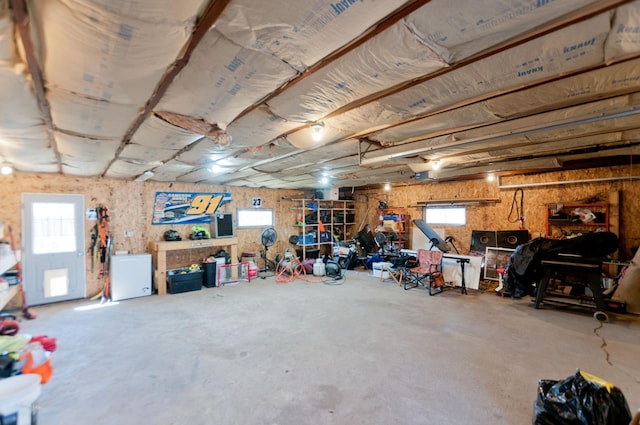 below grade area featuring refrigerator and healthy amount of natural light