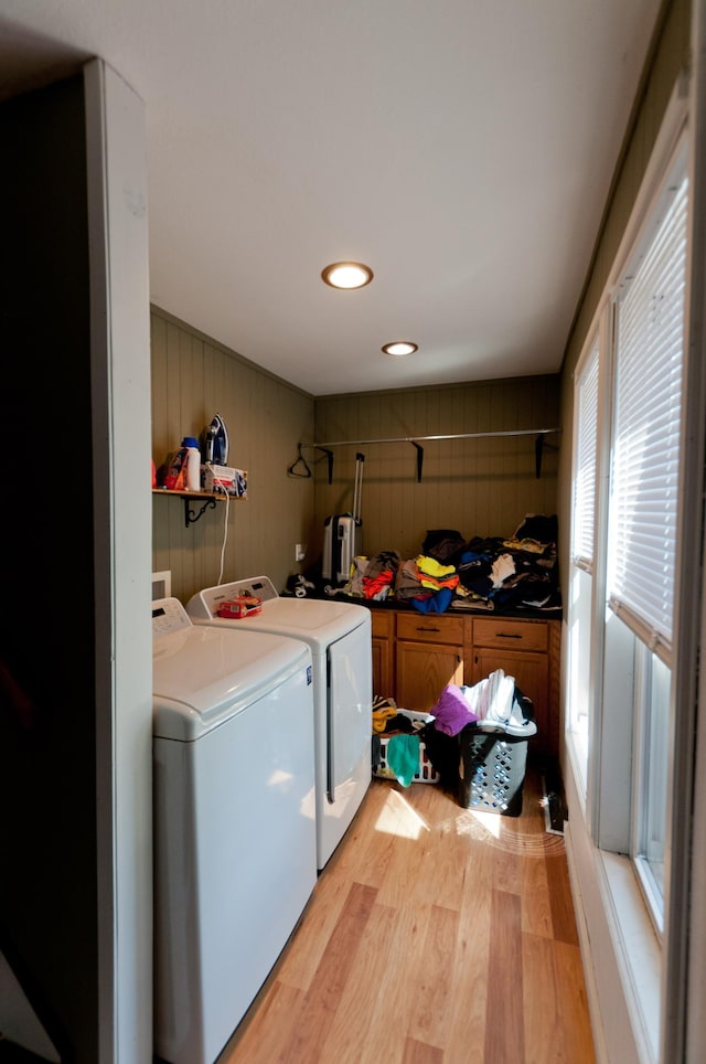 laundry room with washer and dryer, light wood finished floors, and recessed lighting