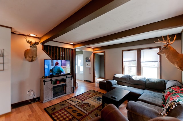 living room featuring healthy amount of natural light, beamed ceiling, light wood finished floors, recessed lighting, and baseboards