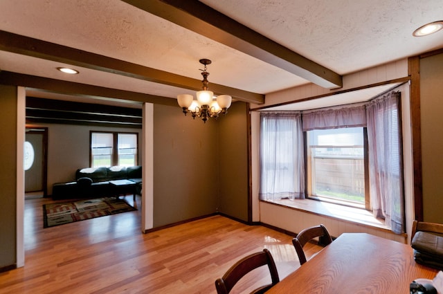 dining space with beamed ceiling, a textured ceiling, a chandelier, light wood-style flooring, and recessed lighting