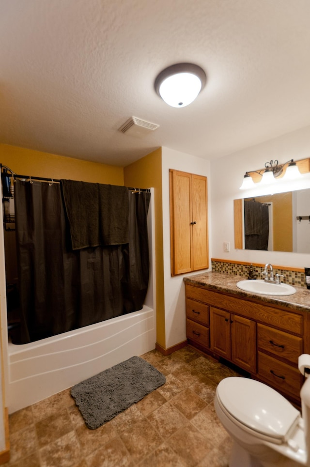full bathroom with toilet, shower / bath combination with curtain, vanity, and baseboards
