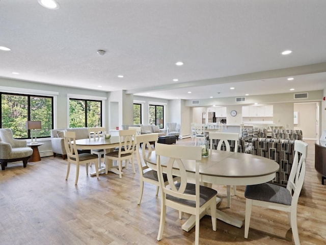 7520 Cahill Rd Unit 222A, Edina, MN 55439 - dining area featuring recessed lighting, light wood-style floors, and a baseboard heating unit