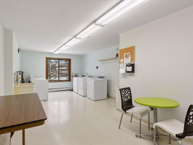 7520 Cahill Rd Unit 222A, Edina, MN 55439 - communal laundry room featuring washer and dryer and a baseboard heating unit