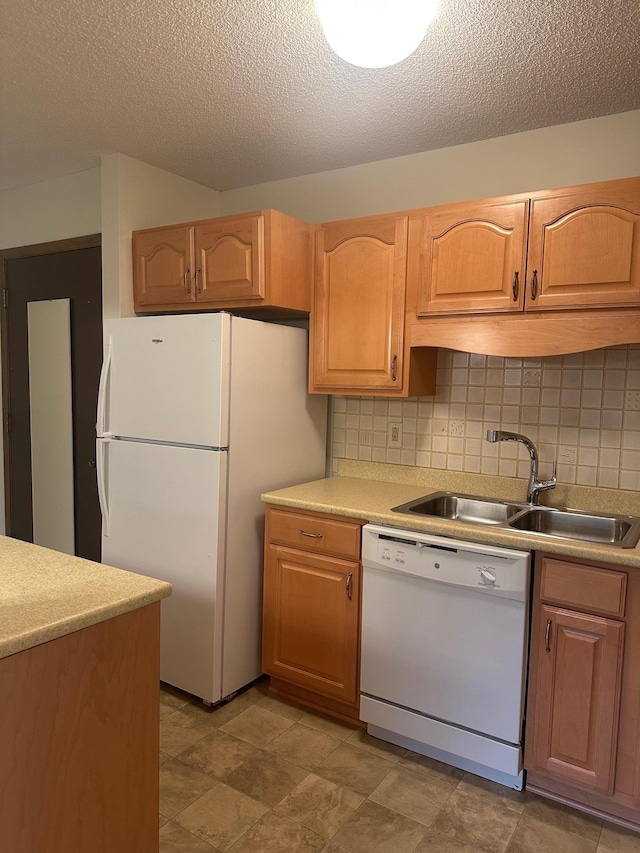 7520 Cahill Rd Unit 222A, Edina, MN 55439 - kitchen with white appliances, a sink, tasteful backsplash, light countertops, and a textured ceiling