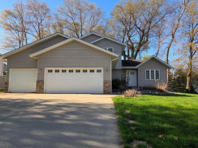 548 Woodland Trl, Medford, MN 55049 - traditional-style house with concrete driveway, a garage, and a front lawn