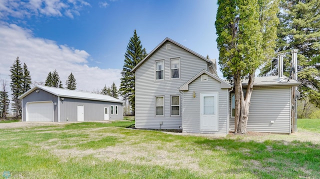 10544 40th St N, Kragnes Twp, MN 56560 - back of property featuring an outdoor structure, a garage, and a lawn