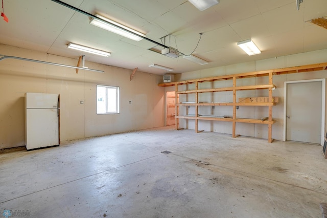 10544 40th St N, Kragnes Twp, MN 56560 - garage with freestanding refrigerator and a garage door opener