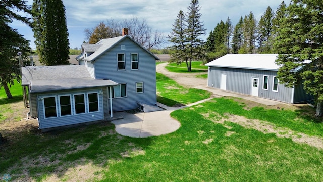 10544 40th St N, Kragnes Twp, MN 56560 - rear view of property with a patio area, a lawn, and a chimney