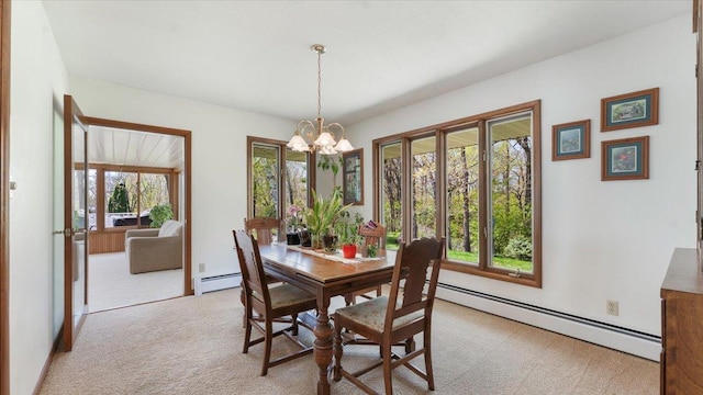 dining space featuring baseboard heating, light colored carpet, and a chandelier