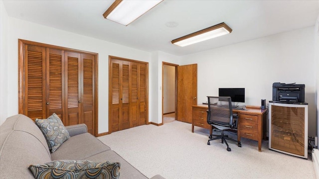 home office featuring light colored carpet and baseboards