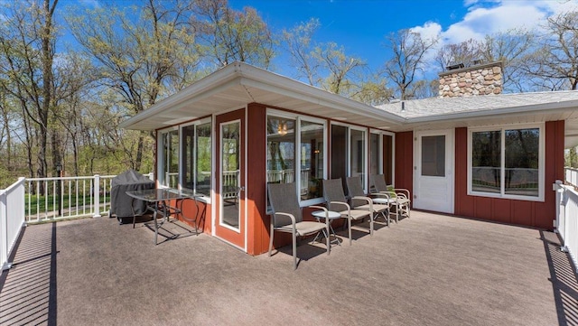 view of patio with a sunroom, area for grilling, and a deck