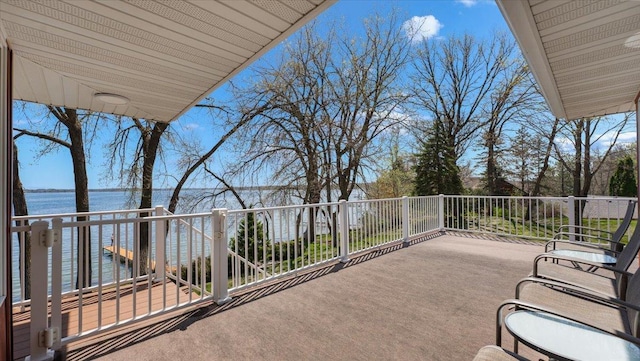view of patio / terrace with a water view and a balcony