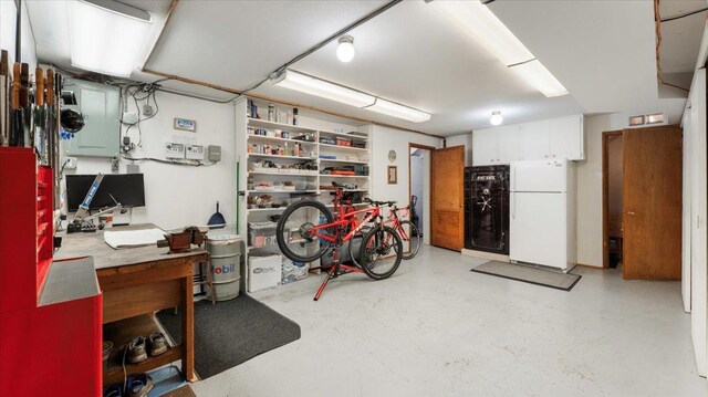 below grade area featuring freestanding refrigerator