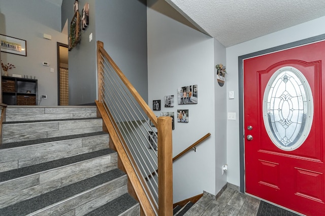 192 Harrison Ave SE, Racine, MN 55967 - entryway featuring a textured ceiling, stairway, and wood finished floors