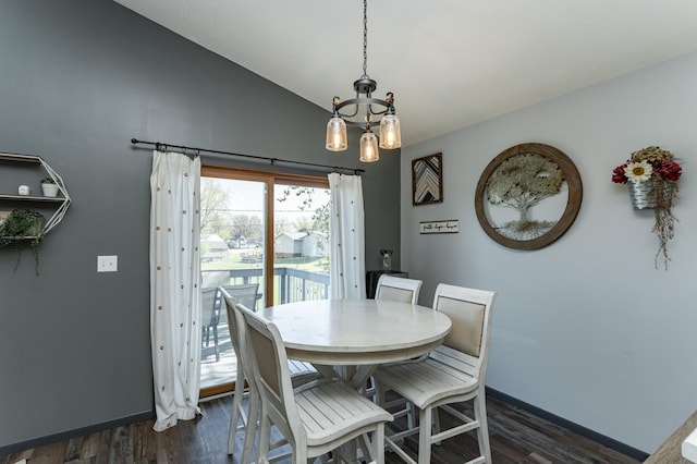 192 Harrison Ave SE, Racine, MN 55967 - dining area featuring dark wood finished floors, a chandelier, baseboards, and lofted ceiling