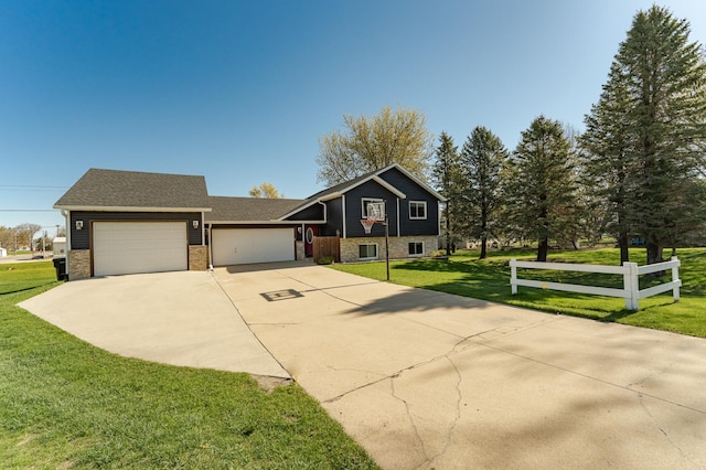 192 Harrison Ave SE, Racine, MN 55967 - tri-level home with an attached garage, driveway, a front lawn, stone siding, and brick siding