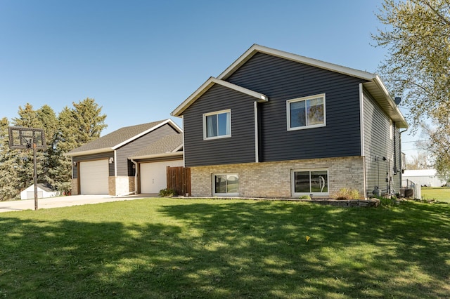 192 Harrison Ave SE, Racine, MN 55967 - split level home with a garage, driveway, a front yard, brick siding, and central AC