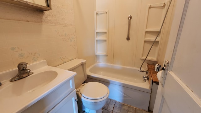 bathroom featuring toilet, vanity, and tub / shower combination