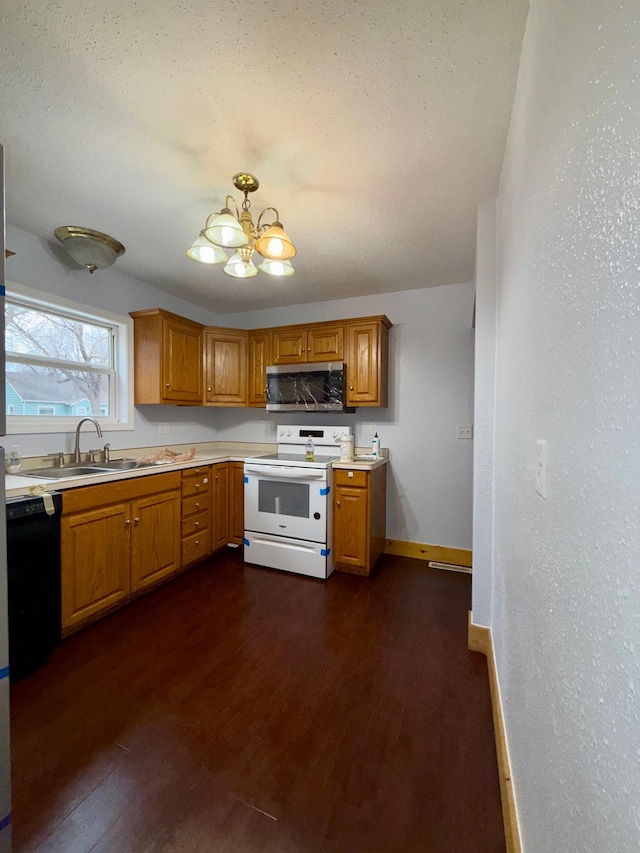 kitchen featuring white electric range, a sink, stainless steel microwave, a chandelier, and dark wood-type flooring