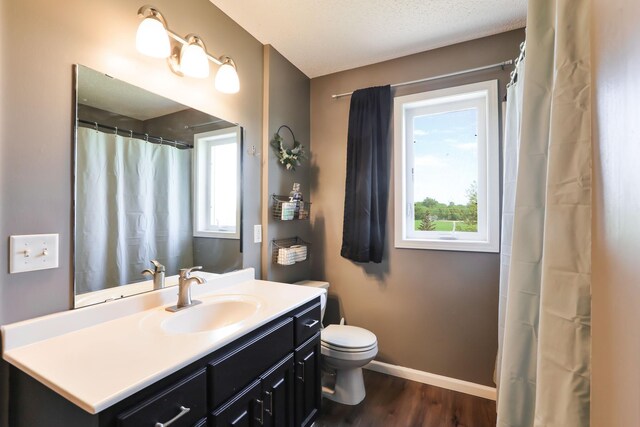 18071 Lincoln Cir NW, Elk River, MN 55330 - full bath with healthy amount of natural light, wood finished floors, toilet, and baseboards