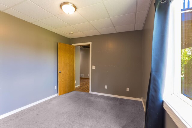 18071 Lincoln Cir NW, Elk River, MN 55330 - spare room featuring carpet, a drop ceiling, and baseboards