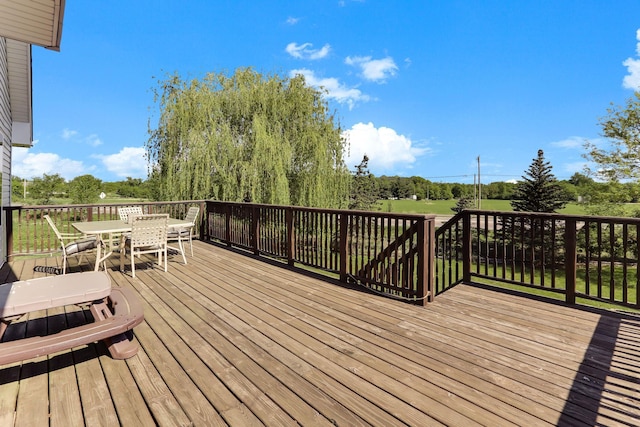 18071 Lincoln Cir NW, Elk River, MN 55330 - wooden deck with outdoor dining area and view of wooded area