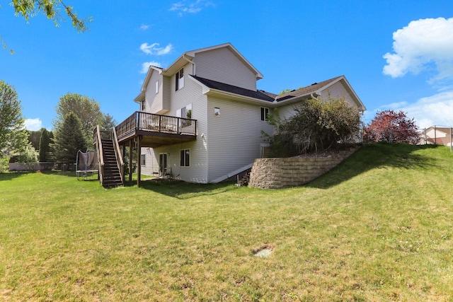 18071 Lincoln Cir NW, Elk River, MN 55330 - back of property with stairs, a wooden deck, and a yard