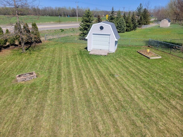 18071 Lincoln Cir NW, Elk River, MN 55330 - view of yard featuring a storage shed, an outbuilding, a vegetable garden, and a view of countryside