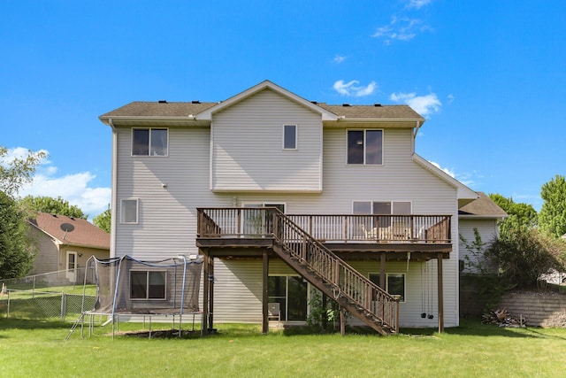 18071 Lincoln Cir NW, Elk River, MN 55330 - back of property featuring stairway, a deck, and a trampoline