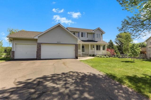 18071 Lincoln Cir NW, Elk River, MN 55330 - traditional-style home with a porch, an attached garage, driveway, brick siding, and roof with shingles