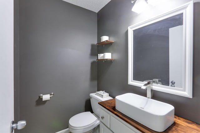 18071 Lincoln Cir NW, Elk River, MN 55330 - half bathroom with toilet, vanity, and a textured ceiling
