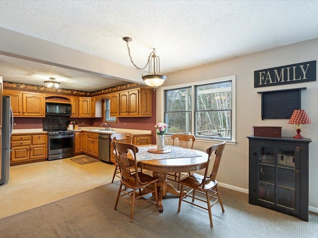 19531 Pine Landing Dr, Grand Rapids, MN 55744 - dining space with a textured ceiling, light carpet, and baseboards