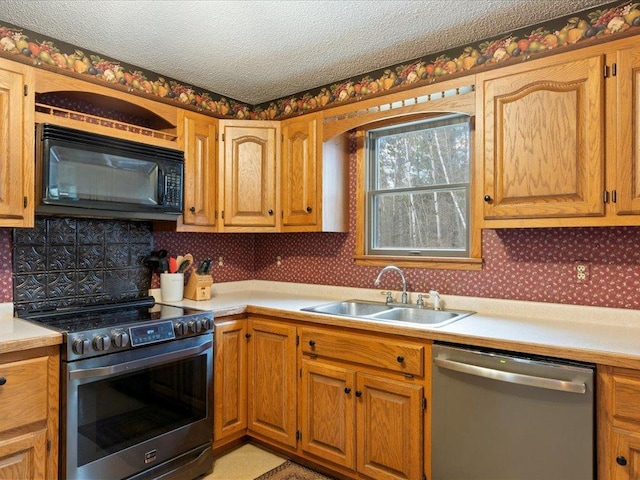 19531 Pine Landing Dr, Grand Rapids, MN 55744 - kitchen featuring appliances with stainless steel finishes, a sink, light countertops, and a textured ceiling