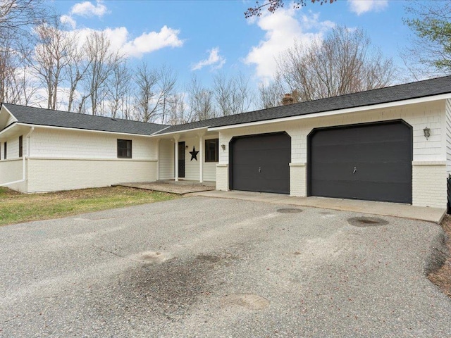 19531 Pine Landing Dr, Grand Rapids, MN 55744 - ranch-style home featuring brick siding, an attached garage, asphalt driveway, a chimney, and a shingled roof