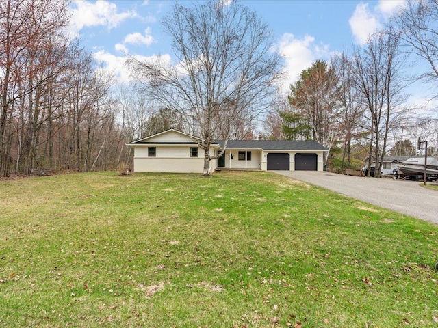 19531 Pine Landing Dr, Grand Rapids, MN 55744 - ranch-style house featuring a garage, asphalt driveway, and a front lawn