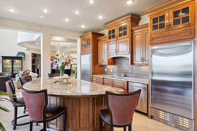 1860 Shoreline Dr, Orono, MN 55391 - kitchen with appliances with stainless steel finishes, recessed lighting, a sink, a center island, and backsplash