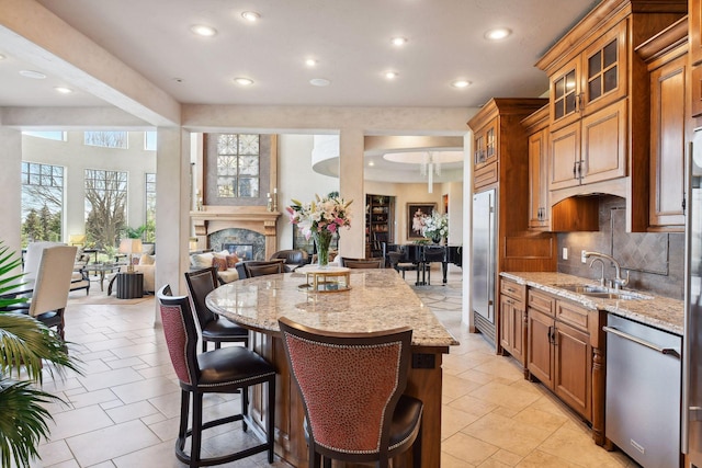1860 Shoreline Dr, Orono, MN 55391 - kitchen with appliances with stainless steel finishes, a sink, brown cabinetry, backsplash, and recessed lighting