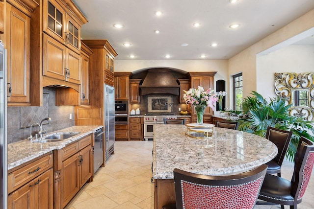 1860 Shoreline Dr, Orono, MN 55391 - kitchen featuring high end appliances, a sink, recessed lighting, brown cabinetry, and tasteful backsplash