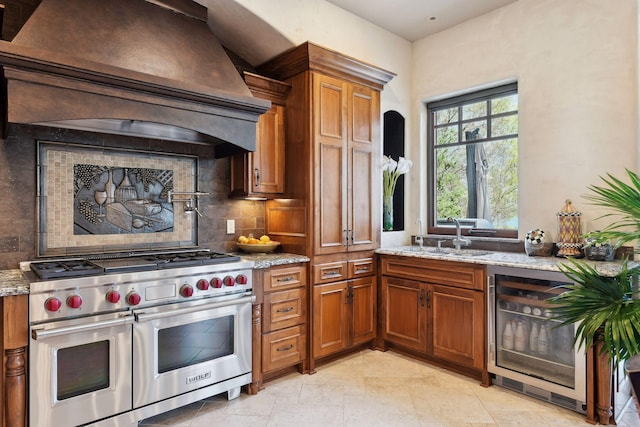 1860 Shoreline Dr, Orono, MN 55391 - kitchen with range with two ovens, custom exhaust hood, a sink, beverage cooler, and brown cabinets
