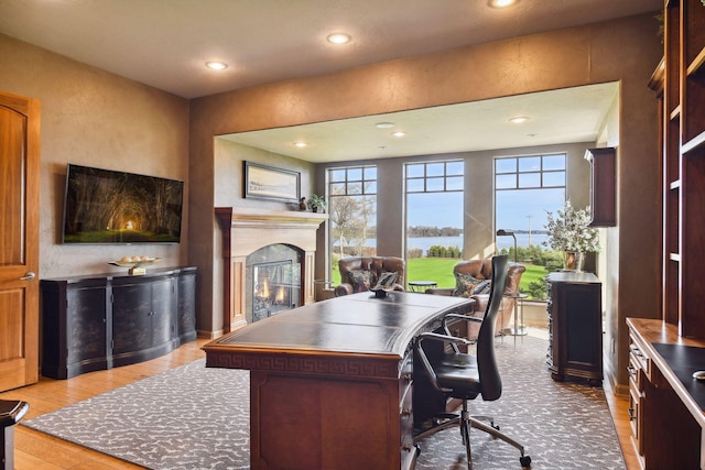 1860 Shoreline Dr, Orono, MN 55391 - office featuring a glass covered fireplace, healthy amount of natural light, recessed lighting, wood finished floors, and a water view