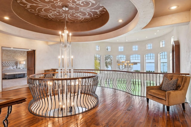 1860 Shoreline Dr, Orono, MN 55391 - staircase with hardwood / wood-style floors, a chandelier, a water view, recessed lighting, and a tray ceiling