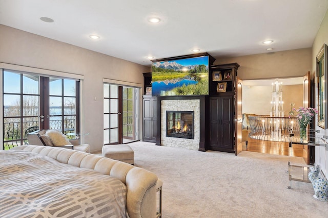 1860 Shoreline Dr, Orono, MN 55391 - bedroom featuring french doors, carpet, access to outside, a tiled fireplace, and recessed lighting