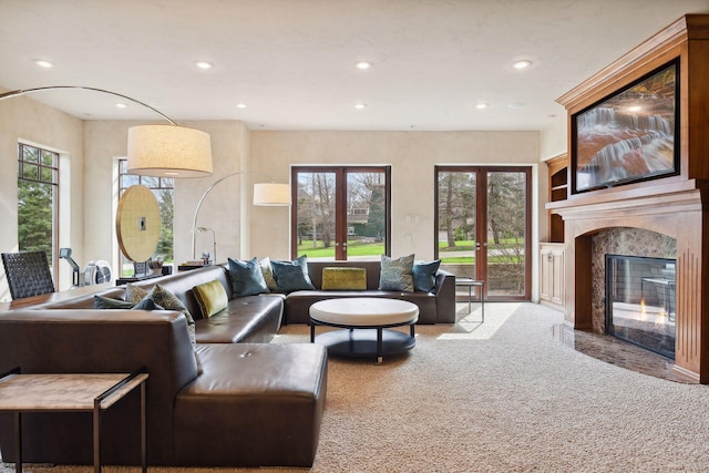 1860 Shoreline Dr, Orono, MN 55391 - living area featuring carpet floors, a high end fireplace, recessed lighting, plenty of natural light, and french doors